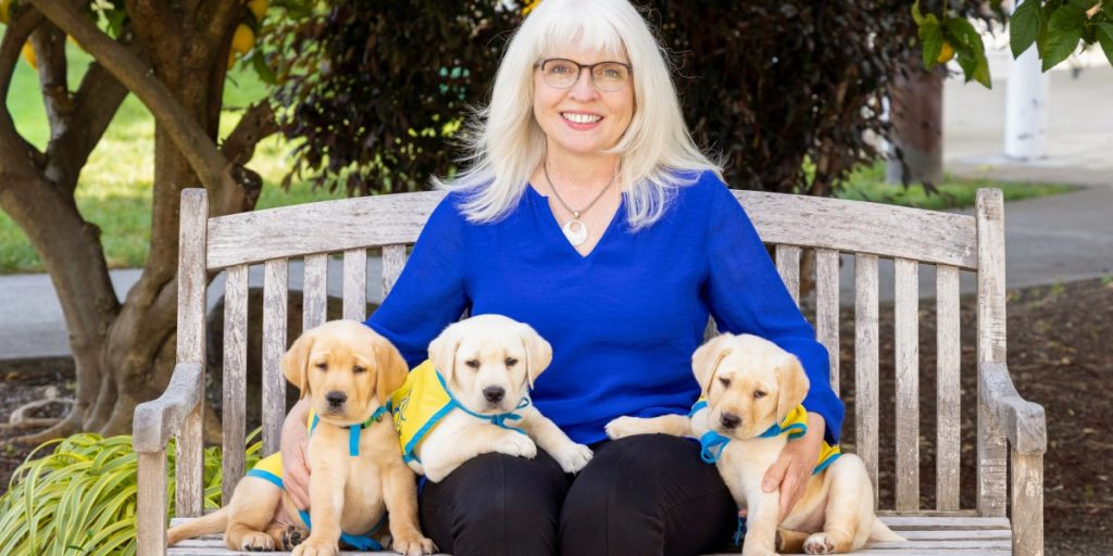 Brenda-Kennedy-with-3-puppies_Photo-credit-Chris-Kittredge.jpg