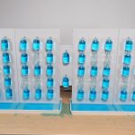 Bottles of Blue Water Spell Out Every Passing Minute on This Unique Digital Clock